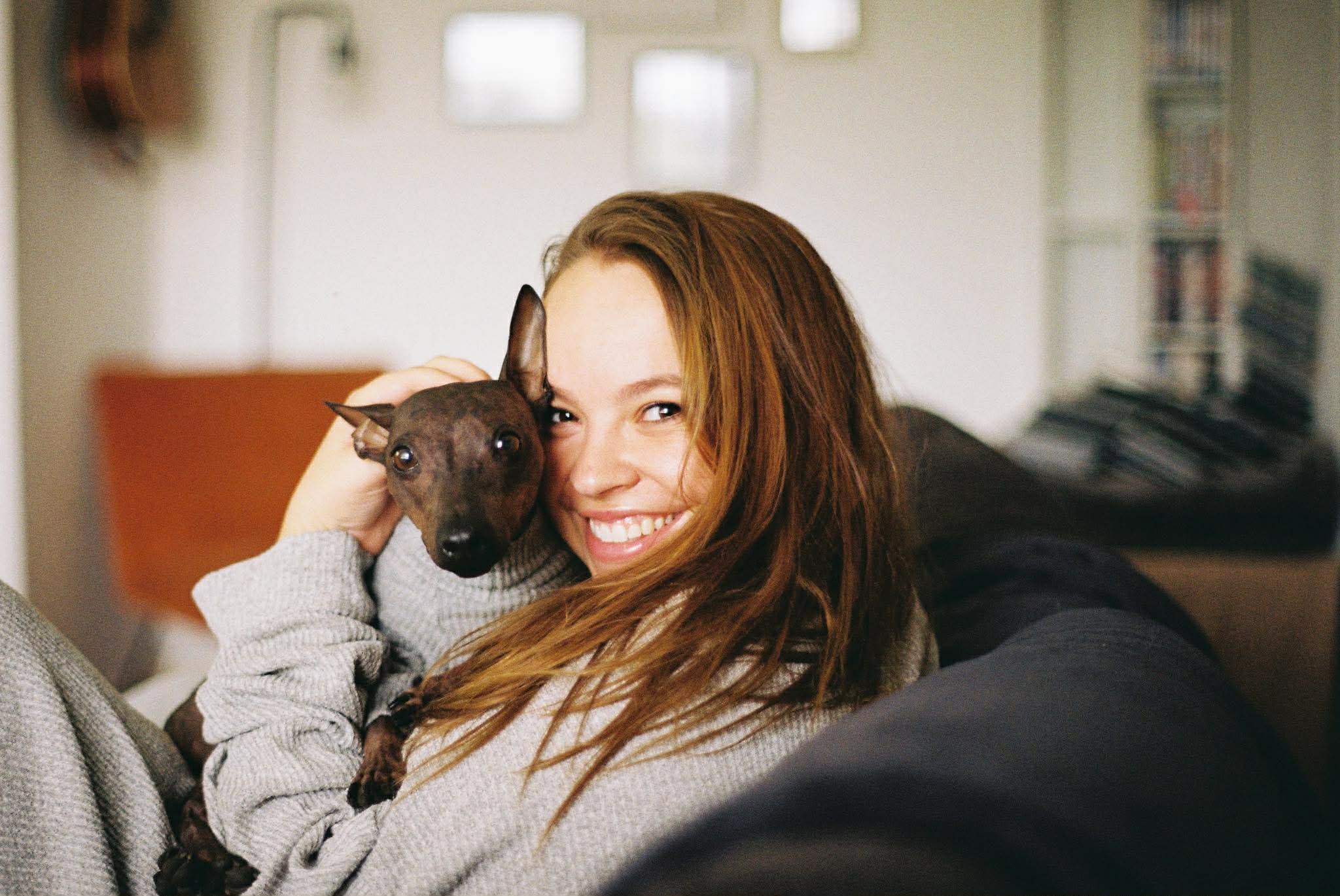 Foster carer relaxing on the couch with their foster dog
